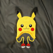 Load image into Gallery viewer, Pokemon Laplander Pikachu Beanie with Pikachu face, rosy cheeks, ears, ear flaps, and Poké Ball tassels.
