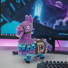 Load image into Gallery viewer, Fortnite Loot Llama 6 Inch Plush toy with vibrant colors displayed on a gaming desk.
