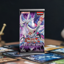 Load image into Gallery viewer, Yu-Gi-Oh! Rage of the Abyss Booster Pack featuring dark and water-themed cards on a table setting.
