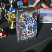 Load image into Gallery viewer, Yu-Gi-Oh! Battles of Legend Chapter 1 set box on display table with trophies.
