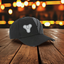 Load image into Gallery viewer, Official Destiny Tricorn Snapback with embroidered design on wooden table.
