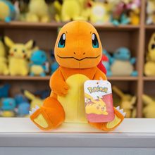 Load image into Gallery viewer, Pokemon 8 Inch Plush - Charmander Sitting on display shelf surrounded by plush toys.
