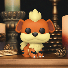 Load image into Gallery viewer, Growlithe Pokémon POP! Vinyl Figure with orange fur and black stripes displayed among candles.
