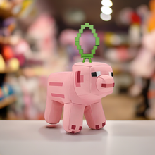 Load image into Gallery viewer, Minecraft 5 Inch Pig Bag Hanger Plush with pixelated design and clip attachment, ideal for backpacks and keys.
