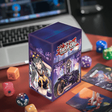 Load image into Gallery viewer, Yu-Gi-Oh! I:P Masquerena deck box with stunning artwork on a desk surrounded by game accessories.
